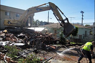 It took 20 minutes for construction crews to tear down the home that, police say, terrorized a Glassell Park neighborhood for 20 years.