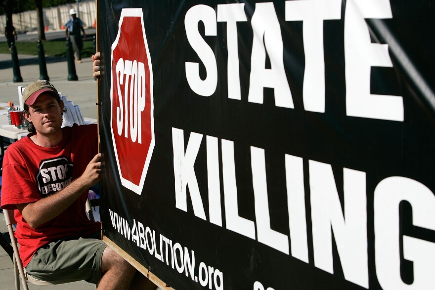Scott Langley of Boston, Massachusetts, holds a banner during a vigil against death penalty in front of the U.S. Supreme Court July 1, 2008 in Washington, DC. The Abolition Action Committee and the National Coalition to Abolish the Death Penalty held the ?Vigil to Abolish the Death Penalty to mark the 1972 and 1976 Supreme Court rulings that suspended the death penalty in the United States and later allowed executions to resume.  
