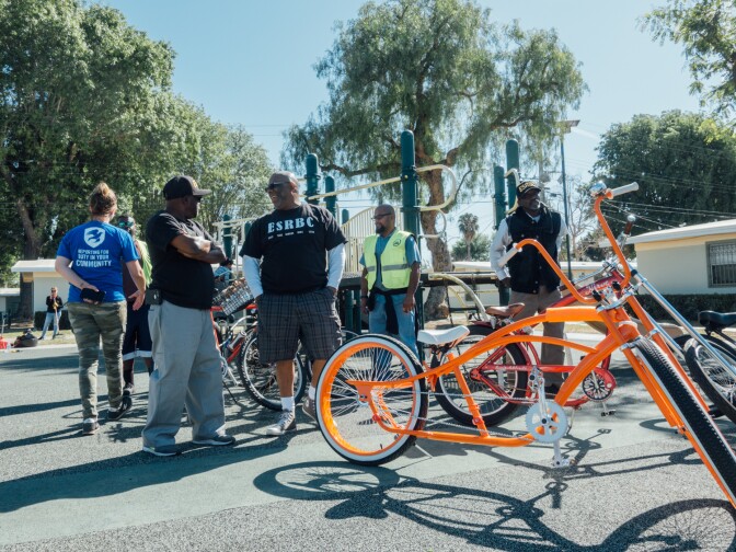 Members of Los Riders and the East Side Riders Bike Club stop by a service project by The Mission Continues at Gonzaque Village in Watts.