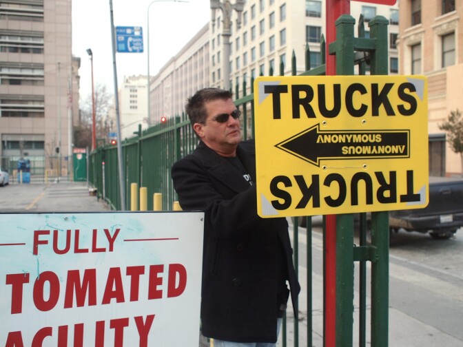 Location Manager Byll Williams setting up signs for a Ford car commercial shoot in Downtown Los Angeles