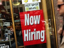Cal State Fullerton economists expect the U.S. and Southern California economy to grow slow but steady through 2014 and accelerate in 2015. (File photo:  A "now hiring" sign is viewed in the window of a fast food restaurant in New York City).  