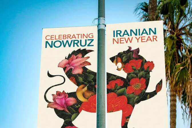 A banner on a streetlight reads "Celebrating Nowruz, Iranian New Year" at UCLA on March 9. It features a winged lion-griffin adorned with nightingales and flowers. In the background, the tops of palms trees can be seen. 