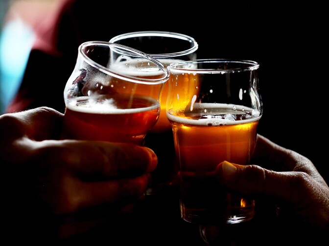 Russian River Brewing Company customers clink their glasses while drinking the newly released Pliny the Younger triple IPA beer on February 7, 2014 in Santa Rosa, California.
