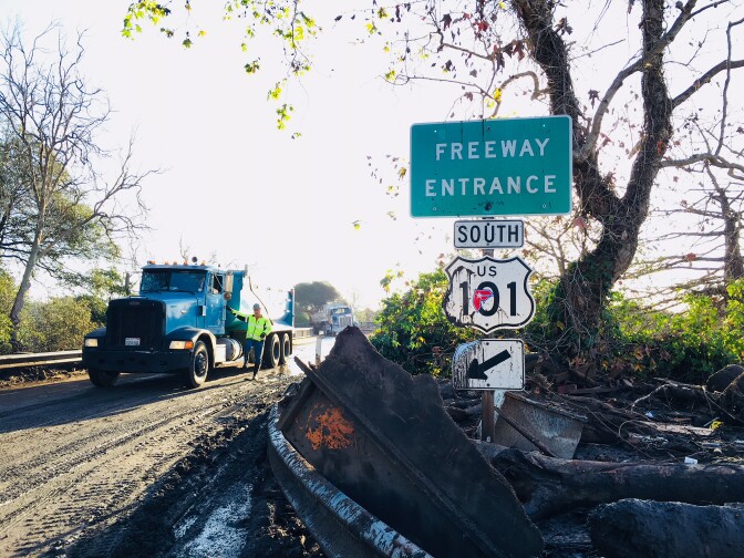 A dirt truck assists with the cleanup of the 101 Freeway on Thursday, Jan. 11, 2018, following the devastating mudslides that killed at least 17 people and destroyed dozens of homes in Santa Barbara County.