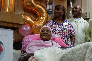 The world's oldest person, Gertrude Baines, naps amidst the media frenzy.