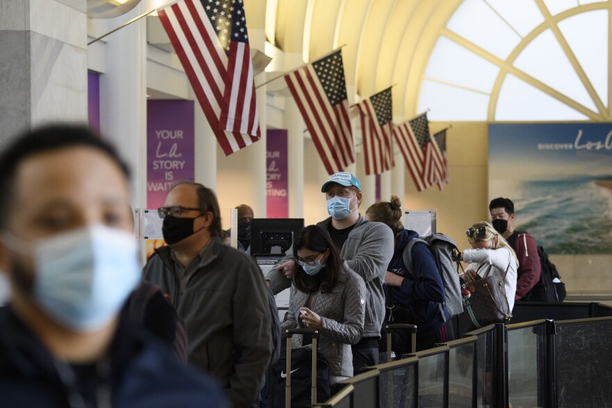 Passengers wait in line to enter a Transportation Security Administration checkpoint at Los Angeles International Airport ahead of the Thanksgiving holiday in Los Angeles, California, November 25, 2020. - US health authorities cautioned Americans on traveling for the Thanksgiving holiday, as the coronavirus spreads out of control. The recommendation was issued by the US Centers for Disease Control and Prevention, the government's health protection agency. (Photo by Patrick T. Fallon / AFP) (Photo by PATRICK T. FALLON/AFP via Getty Images)