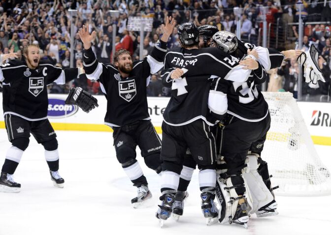 (L-R) Captain Dustin Brown #23, Jarret Stoll #28, Colin Fraser #24, Drew Doughty #8 of the Los Angeles Kings surround goaltender Jonathan Quick #32 of the Los Angeles Kings after winning Game Six of the 2012 Stanley Cup Final 6-1 to win the series 4-2 at Staples Center on June 11, 2012 in Los Angeles.