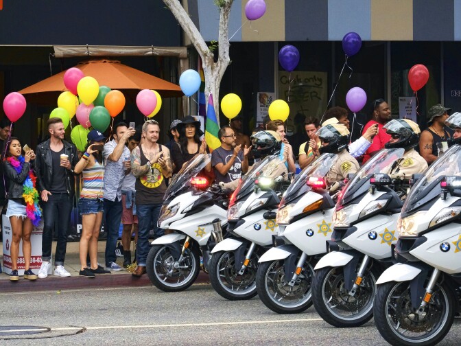 Los Angeles County Sheriff's department motorcycle deputies ride along a street in West Hollywood, Calif., during the Gay Pride Parade on Sunday, June 12, 2016. A heavily armed man arrested in Southern California told police he was in the area for West Hollywood's gay pride parade.
