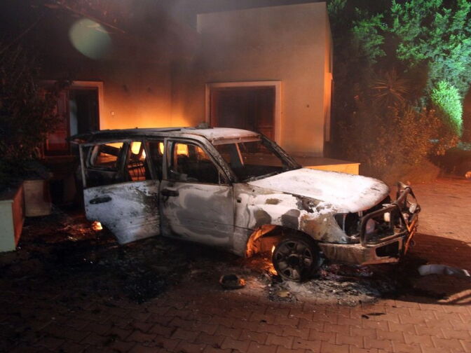 A vehicle and surrounding buildings smolder after they were set on fire inside the U.S. consulate compound in Benghazi late on Sept. 11, 2012. An armed mob protesting over a film they said offended Islam, attacked the U.S. consulate in Benghazi and set fire to the building, killing one American, witnesses and officials said.