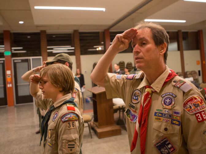 Scoutmaster Larry Turner salutes the flag during the opening ceremony for the weekly meeting of Troop 36 in North Hollywood.