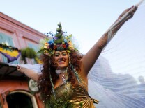 A reveler makes her way through the French Quarter of New Orleans, Louisiana during Mardi Gras festivities on February 9, 2016.