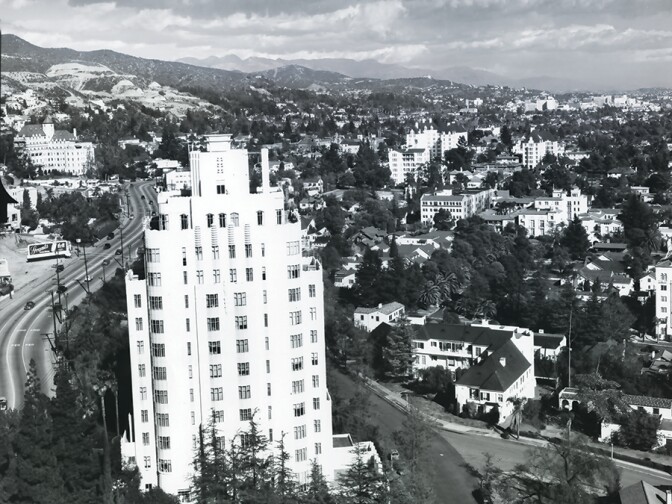 In 1949, Sunset Tower overlooks the Sunset Strip as Sunset Boulevard winds eastward past the Chateau Marmont toward Hollywood, with the Hollywood hills and San Gabriel range in the background.