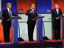 File: Republican presidential candidates (L to R) Donald Trump, Sen. Ted Cruz (R-TX), and Ohio Gov. John Kasich participate in a debate sponsored by Fox News at the Fox Theatre on March 3, 2016 in Detroit, Michigan.