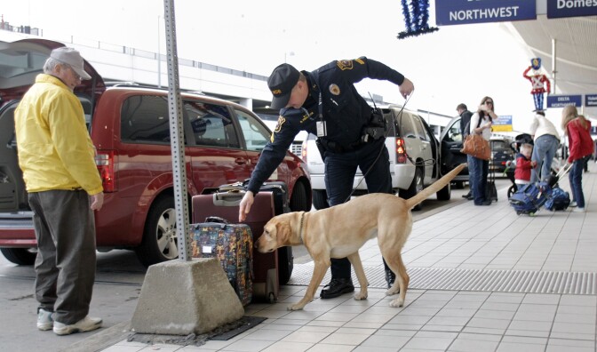 Cpl. Frederick (No first name given) of the Wayne County Airport Police and his bomb-sniffing dog Spencer patrol at the Detroit Metropolitan Airport December 26, 2009 in Romulus, Michigan. On Friday, a Nigerian man allegedly attempted to blow up a Delta airplane that was landing at Detroit Metropolitan airport by igniting an incindiary device while aboard the aircraft. Cpl. Frederick's dog was wounded while working in Iraq and was brought back to the U.S. to recover. 