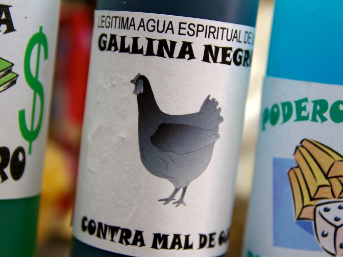 One of the dozens of agua espiritual bottles at the counter of a botanica.