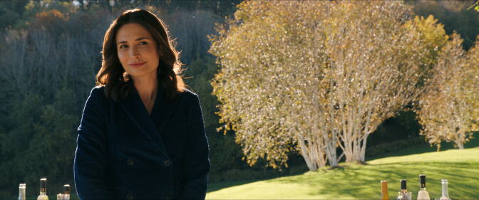 A photo from a TV show featuring a woman in a peacoat.