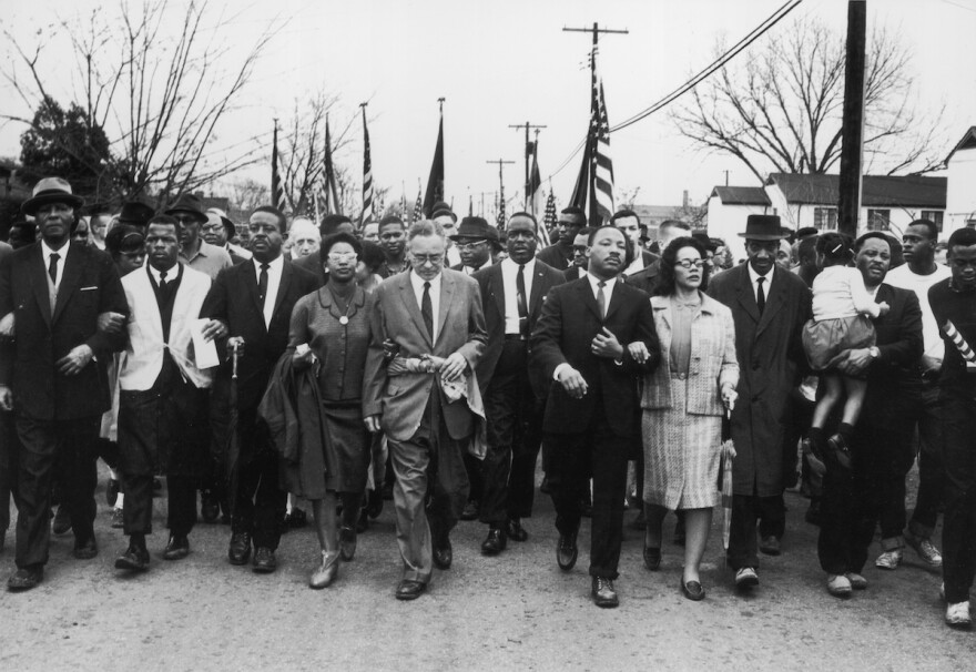 A group of people led by Martin Luther King Jr. at front and center, march from Selma To Montgomery in 1965