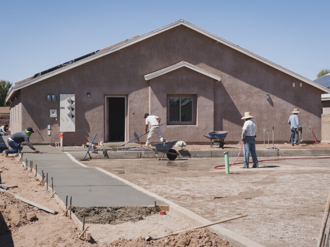 A construction crew works on a new single-family home on the Fort Yuma Indian Reservation in California, where the Quechan Tribe is using a new tax credit program to fund construction of a 44-unit affordable housing project.  