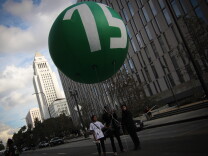 The Los Angeles City Council on Tuesday, May 19, 2015, approved a proposal that calls for raising the city’s minimum wage to $15 an hour by 2020. (File photo shows balloon used during a rally and march to demand the increase to $15.)