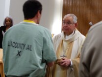                               Archbishop José H. Gomez gives communion to an inmate at Los Angeles County Jail during Christmas Day mass, Dec. 25, 2017.