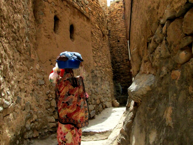 Woman on Main Street of the village Misfat al Albriyyin