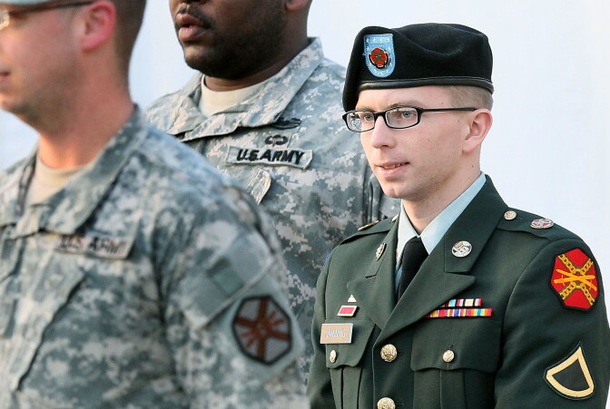 Army Private Bradley Manning is escorted away from his Article 32 hearing February 23, 2012 in Fort Meade, Maryland. 