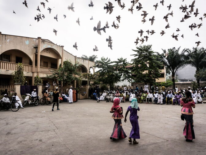 People congregate in a square before breaking the Ramadan fast, as part of the Eid al-Fitr holiday, on June 25, 2017 in Kinshasa.  
Muslims worldwide celebrate the Eid al-Fitr holidays, which mark the end of the holy fasting month of Ramadan.  / AFP PHOTO / JOHN WESSELS        (Photo credit should read JOHN WESSELS/AFP/Getty Images)