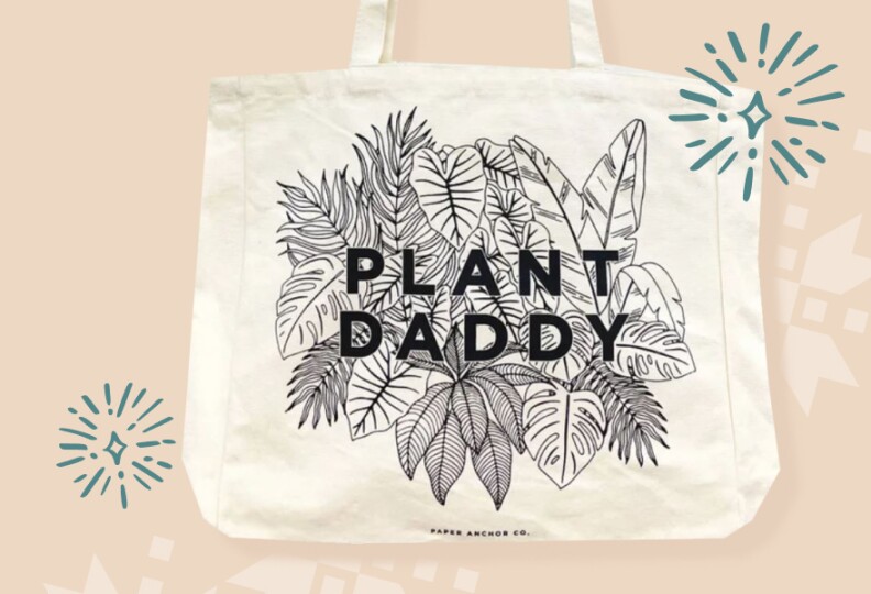 A tote has black and white line drawing of leave with words: Plant Daddy