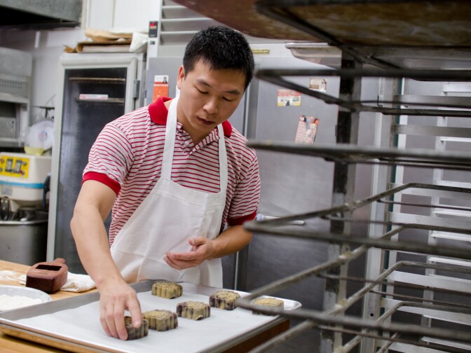 Kenny Huang, a baker, places formed Mooncakes onto a tray after molding them at Olympic Bakery in Temple City, Calif., Monday September 24, 2012. The small pastries are made for the Chinese Moon Festival which takes place during the eight lunar month each year.