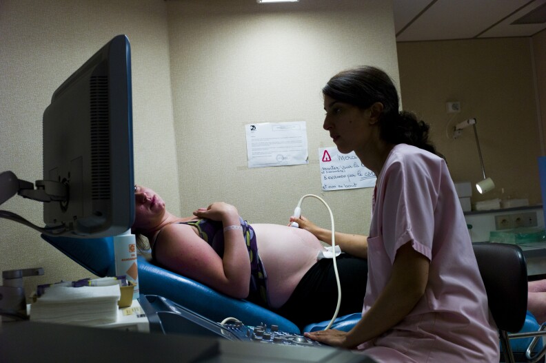 A doctor makes an ultrasound to a patient at the maternity of the Argenteuil hospital, in a Paris suburb, on July 22, 2013.
