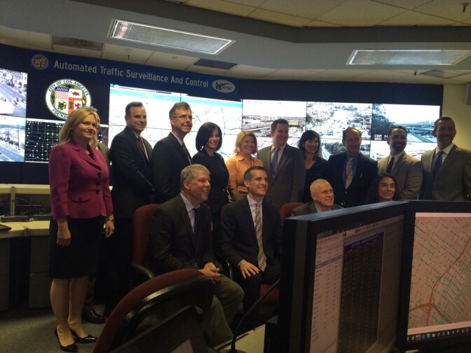 Mayor Eric Garcetti, front row, second from left, surrounded by city officials as he describes a data swapping agreement with Waze, the Google-owned traffic app.