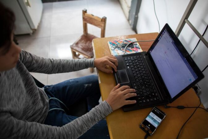 CARACAS, VENEZUELA - APRIL 27: A teenager student Jose Lara studies his daily schoolwork on his laptop at his home in the slum of Catia during the second month of quarantine in the Country on April 27, 2020 in Caracas, Venezuela. Due to the government-ordered coronavirus lockdown, students in Venezuela will have to attend classes remotely until the end of the school year on July 10th. In most cases, teachers connect with their students daily or weekly through e-mail or social media. Online education is a challenge in a country with a very unstable and slow internet service, frequent power outages and low-income households where parents lack of time to spend teaching their kids. (Photo by Leonardo Fernandez Viloria/Getty Images)