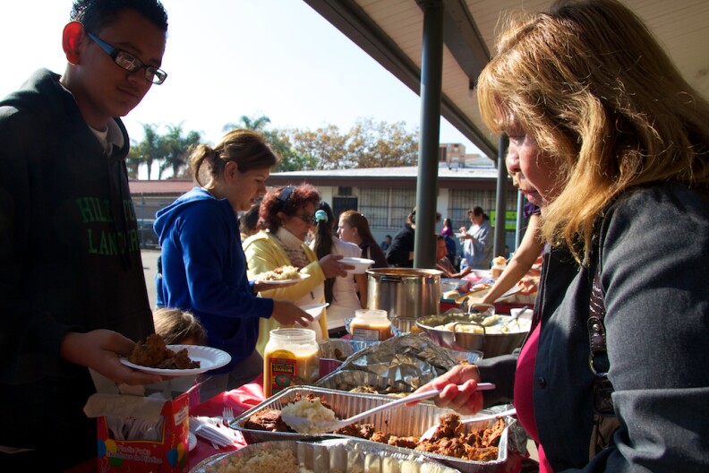 Volunteer Guadalupe Flores passes out food during CHIRLA's event on November 23, 2011.