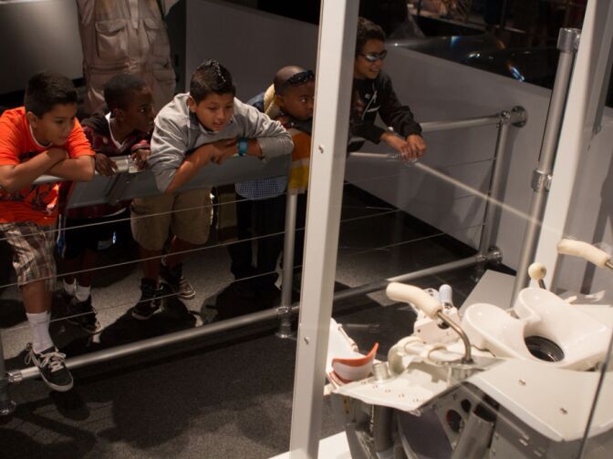 Children look at a toilet used on space shuttle Endeavour during a preview of Endeavour: The California Story exhibit at the California Science Center.
