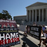 WASHINGTON, DC - JUNE 29: Protesters with signs gather outside of the U.S. Supreme Court June 29, 2015 in Washington, DC. Today the high court ruled on the controversial drug that was implicated in botched executions, state efforts to reduce partisan influence in congressional redistricting and Environmental Protection Agency limits on the emission of mercury and other toxic pollutants from power plants.  (Photo by Mark Wilson/Getty Images)