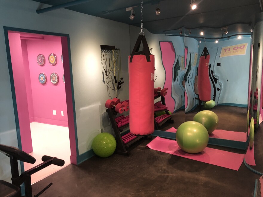 The Gym selfie room at the Museum of Selfies features funhouse mirrors and weights that are not quite what they appear.