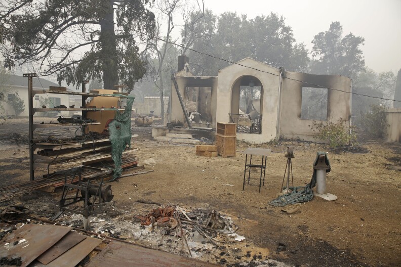 Only a frame and few items still stand at home destroyed by fire Sunday, Sept. 13, 2015, in Middletown, Calif. California Gov. Jerry Brown has declared a state of emergency in Lake and Napa Counties after a wildfire charred more than 60 square miles within 12 hours, prompting thousands to flee their homes. Brown said Sunday the declaration will expedite debris removal and waive fees to people who need to replace official documents lost in the fire.  The blaze, about 100 miles north of San Francisco, has destroyed an unconfirmed number of homes and other buildings and damaged highways and other infrastructure.(AP Photo/Eric Risberg)