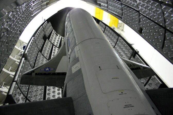 This April 2010 photo released by the U.S. Air Force shows the X-37B Orbital Test Vehicle in the encapsulation cell at the Astrotech facility in Titusville, Fla. The U.S. Air Force's secrecy-shrouded X-37B unmanned spaceplane returned to Earth early Friday after more than seven months in orbit on a classified mission, officials said. (AP Photo/U.S. Air Force)