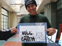 Luis Alfara, 19, shows off his screen print that was on display today at the L.A. Central Library.