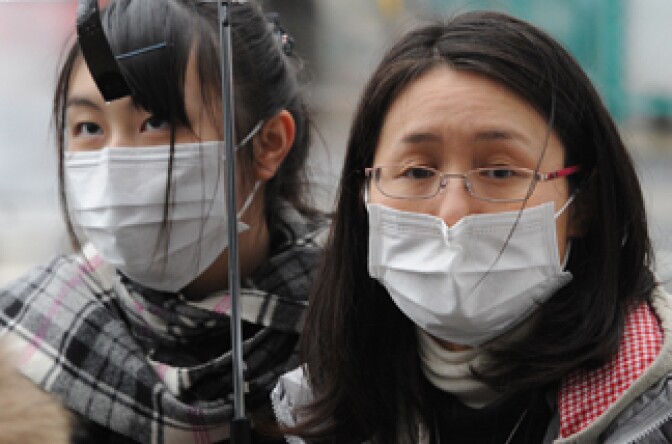 People queue up for buses at a station to get out of the city in Yamagata, Yamagata prefecture on March 15, 2011.