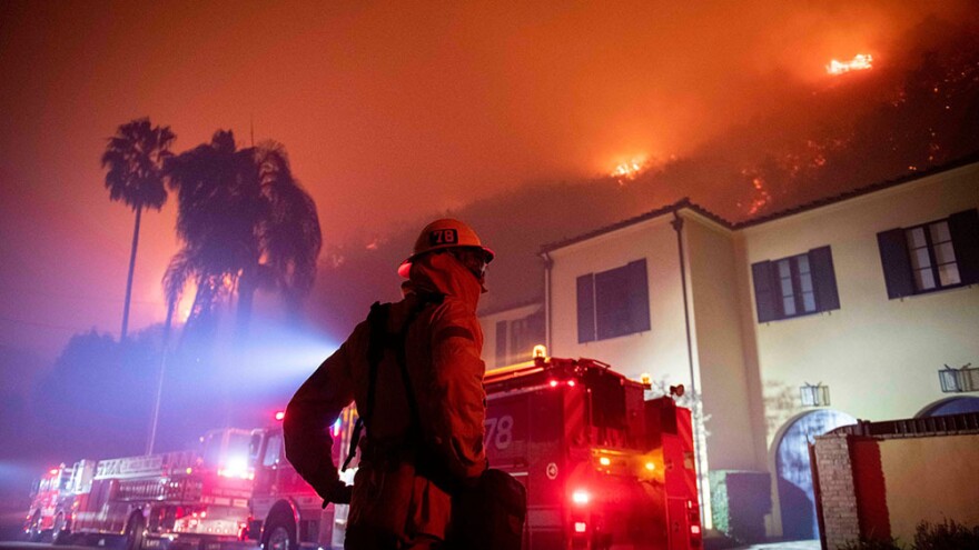 Firefighters establish a perimeter during the Getty fire.