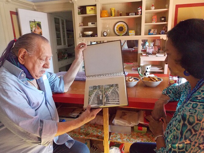 Emil Girardi, 83, and Shipra Narruhn, 67, chat in Girardi’s San Francisco apartment. They were paired through a nonprofit called Little Brothers, Friends of the Elderly, which aims to relieve isolation and loneliness in seniors like Girardi.