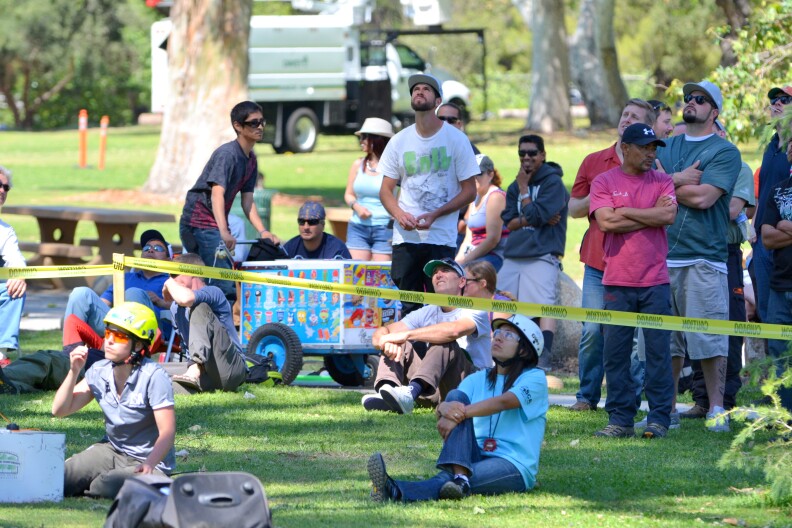 Onlookers gather to watch the Masters' Challenge, which determines who will compete in the International Tree Climbing Championship.