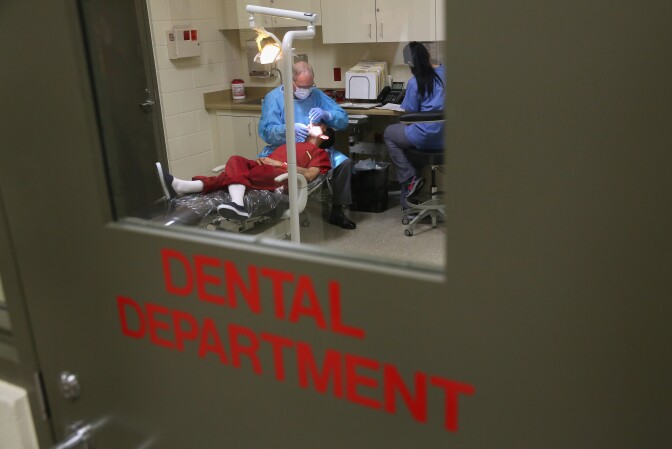 ADELANTO, CA - NOVEMBER 15: An immigrant receives dental care at the Adelanto Detention Facility on November 15, 2013 in Adelanto, California. The center, the largest and newest Immigration and Customs Enforcement (ICE), detention facility in California, houses an average of 1,100 immigrants in custody pending a decision in their immigration cases or awaiting deportation. The facility is managed by the private GEO Group. ICE detains an average of 33,000 undocumented immigrants in more than 400 facilities nationwide. (Photo by John Moore/Getty Images)