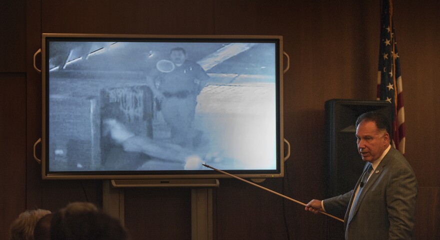 Orange County District Attorney Tony Rackauckas shows the jury an image of former Fullerton police officer Manuel Ramos and Kelly Thomas at the Fullerton Transportation Center on July 5, 2011 during the trial of former Fullerton officers Ramos and Jay Cicinelli on Monday, Dec. 2, 2013 in Santa Ana, Calif.  Rackauckas told jurors that Ramos and Cicinelli were responsible for the death of 37-year-old Kelly Thomas in July 2011. Thomas, whose family says was schizophrenic, died five days after the violent confrontation with six officers who responded to a call about a man jiggling car door handles in a transit center parking lot. Ramos is charged with second-degree murder and involuntary manslaughter. Cicinelli is charged with to involuntary manslaughter and use of excessive force. Defense attorneys are seeking to introduce evidence that Thomas had a history of violence and suffered from psychotic episodes due to prolonged methamphetamine abuse.