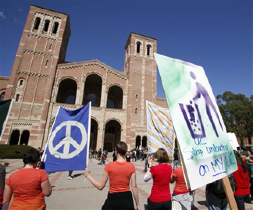 Demonstrators carrying a banner that says "I Can't Afford to go to College. Solution: No Cuts" past Royce Hall on the campus at UCLA in Los Angeles Thursday, March 4, 2010. Students, teachers, parents and others rallied throughout California and many other states to protest deep cuts in funding for schools and universities. Governor Jerry Brown announced another round of cuts to higher education Monday, Jan. 10, 2010.