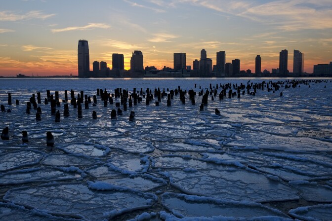 Ice floes fill the Hudson River as the New Jersey waterfront is seen during sunset on January 9, 2014 in New York City. A recent cold spell, caused by a polar vortex descending from the Arctic, caused the floes to form in the Hudson.  