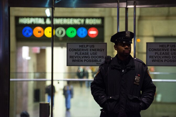 A New York City Police officer stands at the entrance to Bellevue Hospital Oct. 23, 2014 in New York City. After returning to New York City from Guinea where he was working with Doctors Without Borders treating Ebola patients, Dr. Craig Spencer was quarantined after showing symptoms consistent with the virus. Spencer was taken to Bellevue hospital to undergo testing.