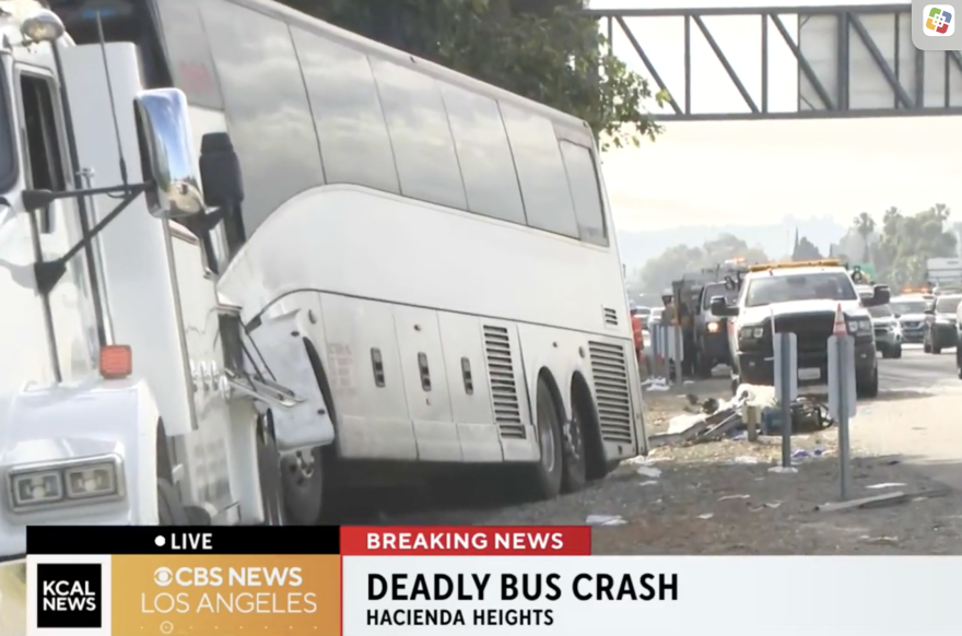A bus is along the side of the road with debris nearby.