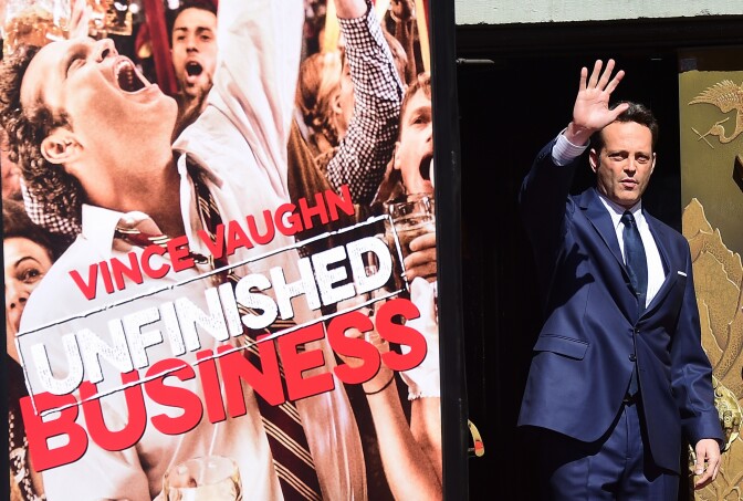 Actor Vince Vaughn waves on arrival for his Handprint and Footprint Ceremony in front of the TCL Chinese Theater IMAX in Hollywood, California on March 4, 2015. Vaughn made his cinematic debut in the 1993 underdog film Rudy, where he also became friends with fellow actor Jon Favreau and forged a creative partnership that led to his break-out role in Favreaus 1996 film-turned-cult-classic Swingers. AFP PHOTO/  FREDERIC J. BROWN        (Photo credit should read FREDERIC J. BROWN/AFP/Getty Images)
